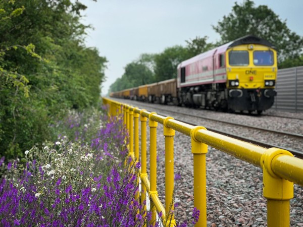 Image of train delivering materials for construction by rail on track between Bicester and Bletchley.