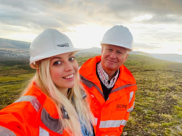 Two EWR employees on a hill in hi vis jackets