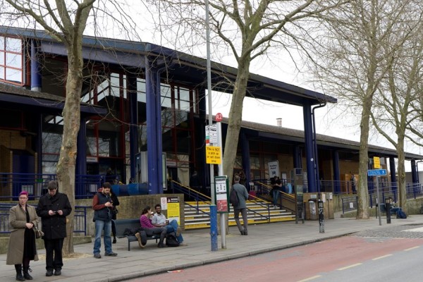 People sitting on a bench outside a building