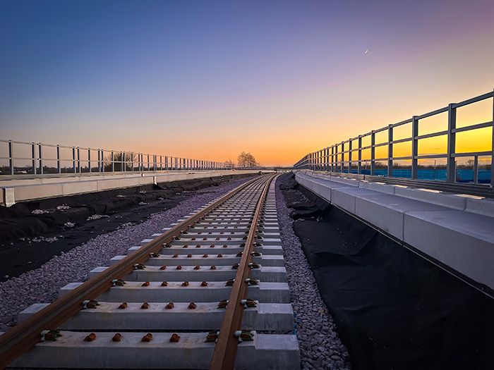Close up of train tracks with sunset in background