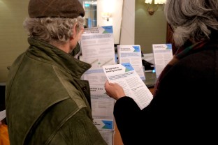 Two people reading EWR leaflet