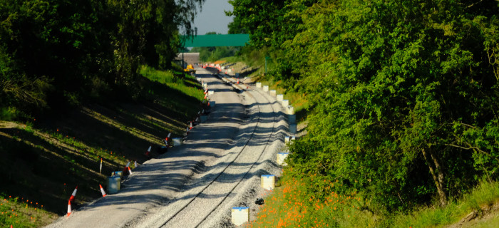 Train track with trees either side