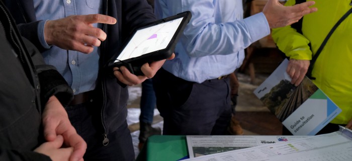 People on ipad at consultation event