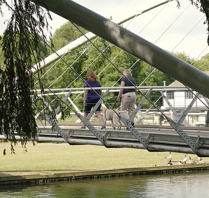 2 people walking on bridge
