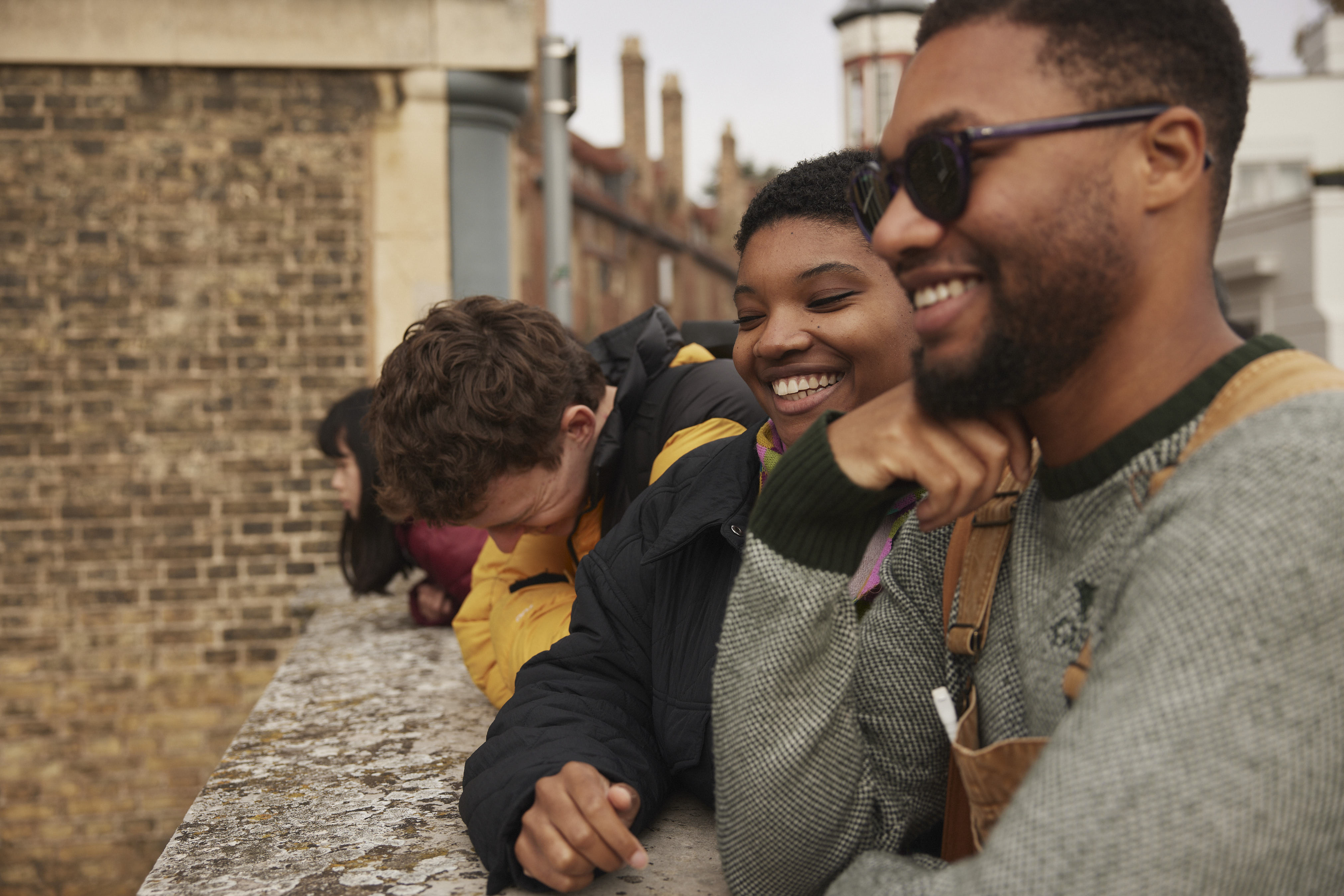 Closeup-of-group-of-friends-in-Cambridge-looking-over-bridge