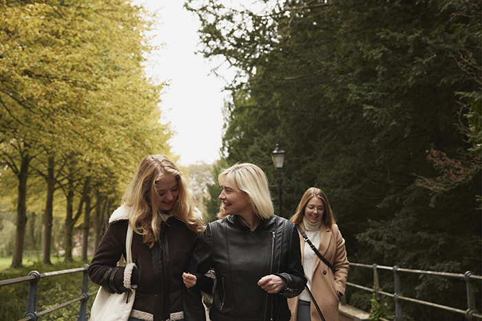 group of women walking through park